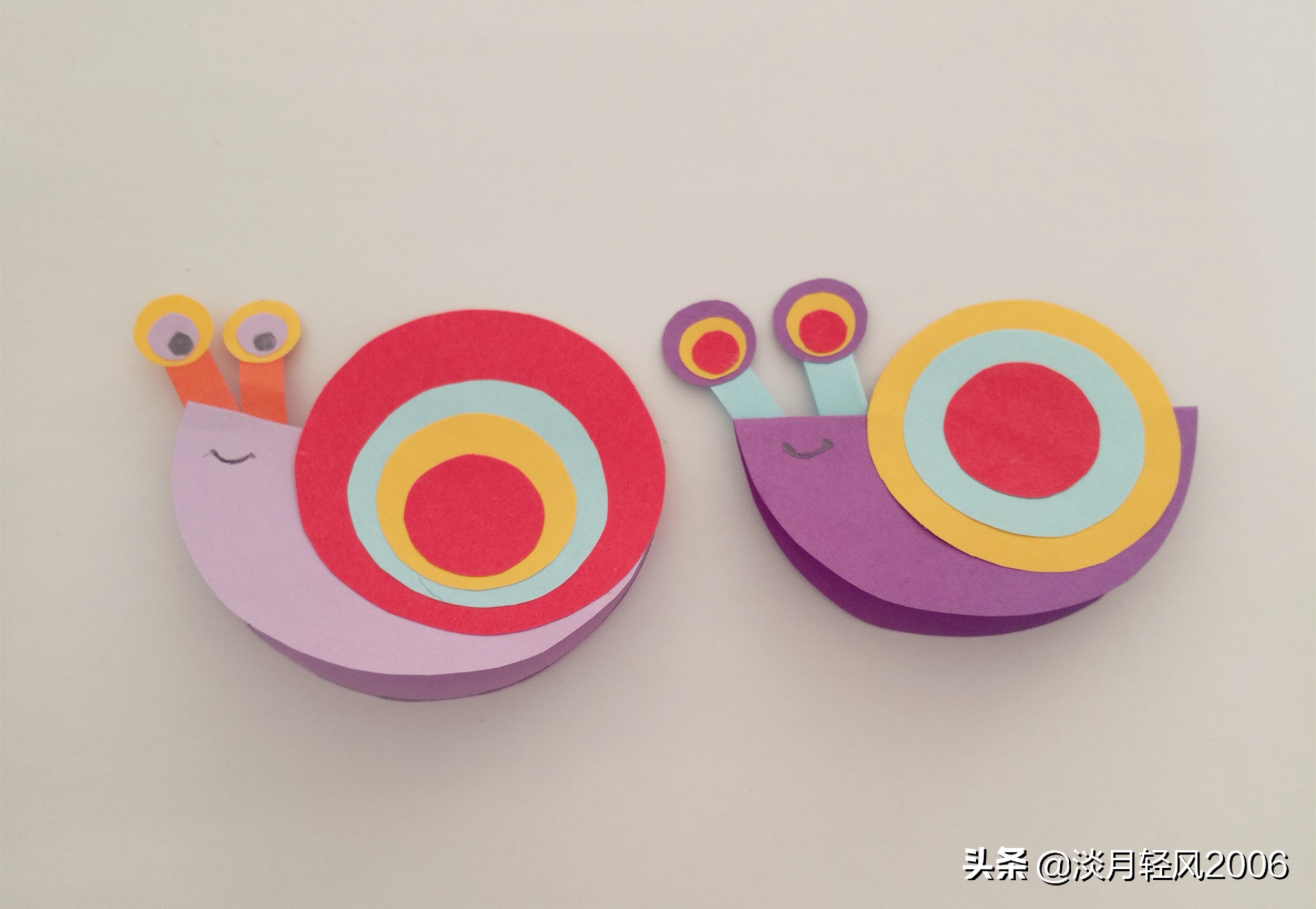 幼儿园亲子手工,用彩色卡纸剪10个圆两个长条,做出一个小蜗牛