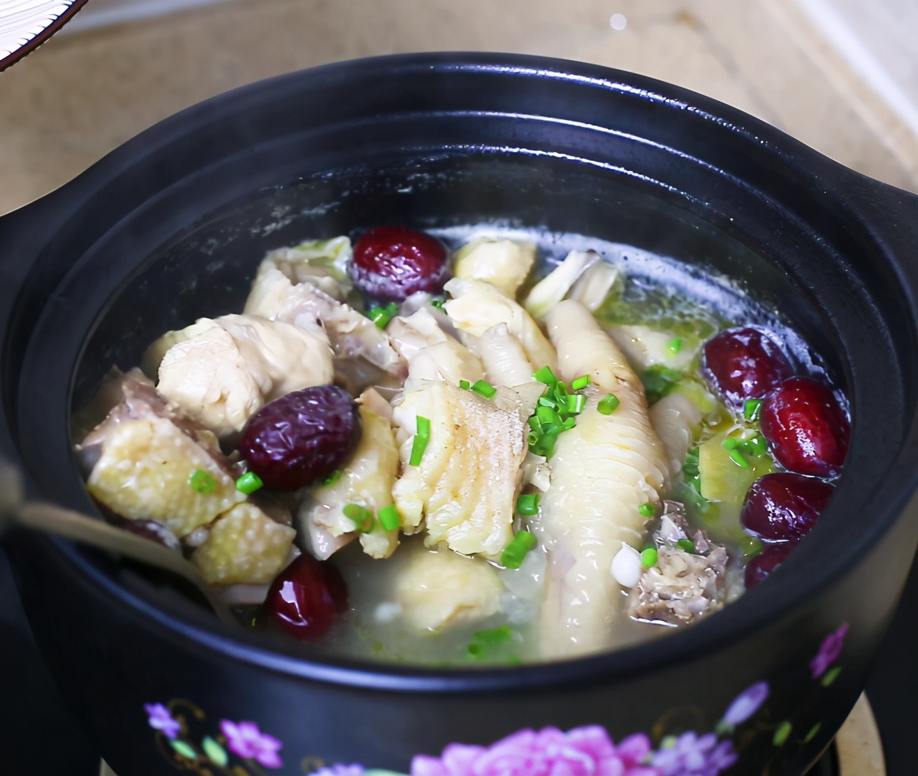 加入姜片和葱炒,然后加入足够的水,加入鸡肉和火腿煮沸,用小火炖1小时