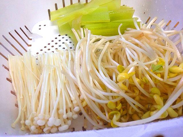 水烧开后放入黄豆芽和金针菇,再次烧开后放入黄豆芽和金针菇,煮一下